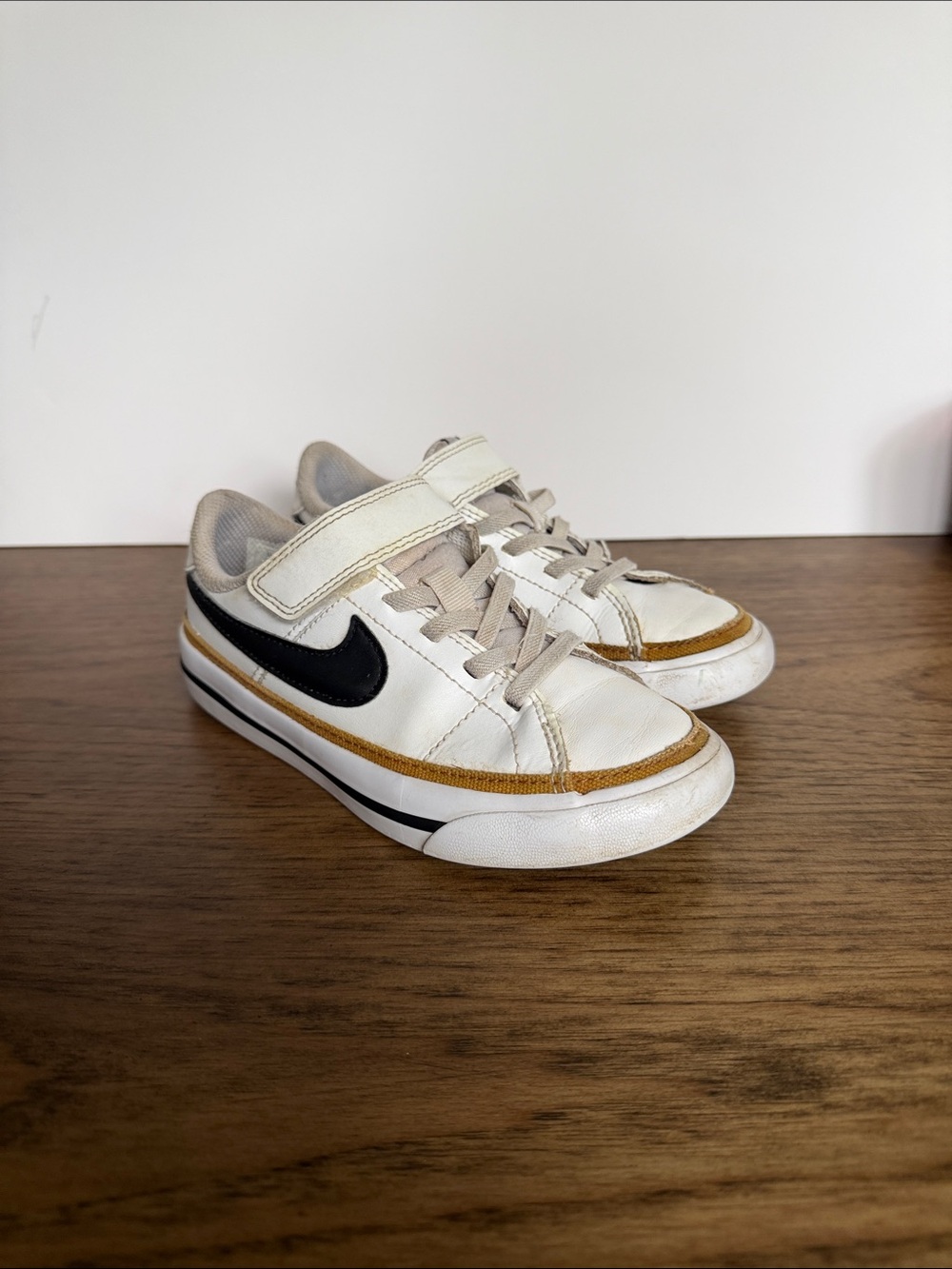 Nike Kids White Sneakers with Black Swoosh and Brown Trim